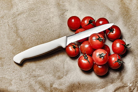 Tomatoes With Knife on Brown Surface