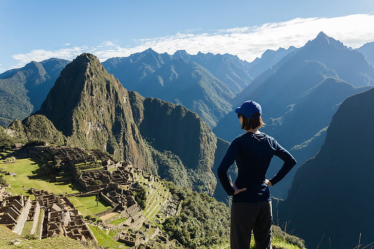 girl standing on Mossu Piccu, Peru under blue sky