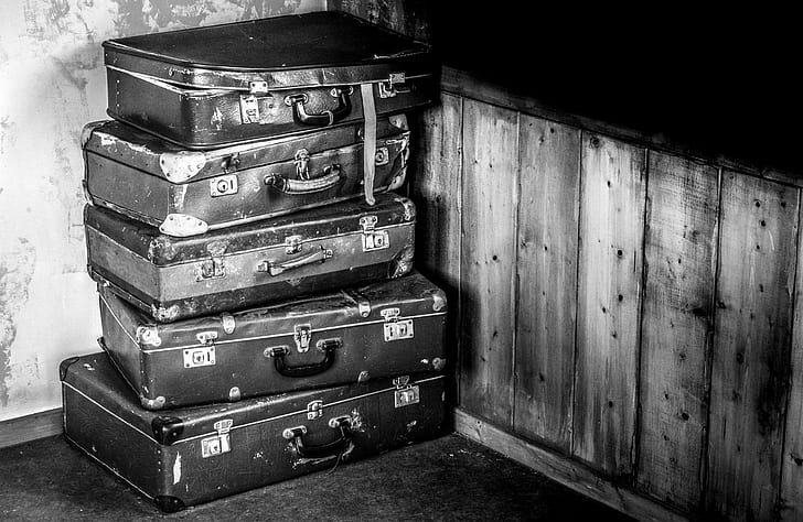 stacked briefcase in grayscale photography