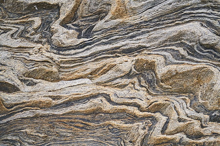 brown, white, and black marble surface