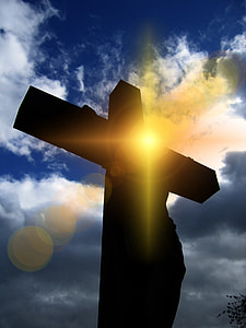 silhouette photo of person on cross