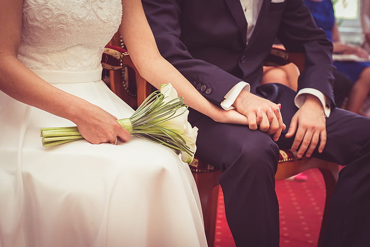 bride and groom sitting on chair
