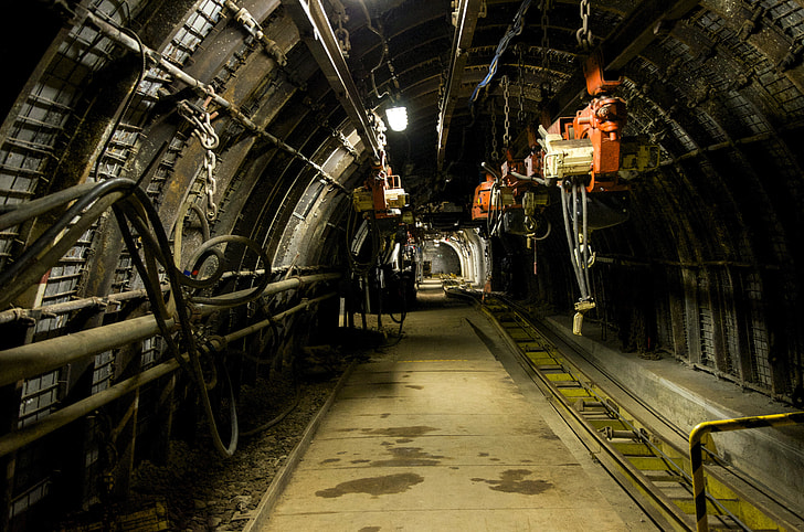 photo of tunnel with orange electric hoist hanging on the ceiling