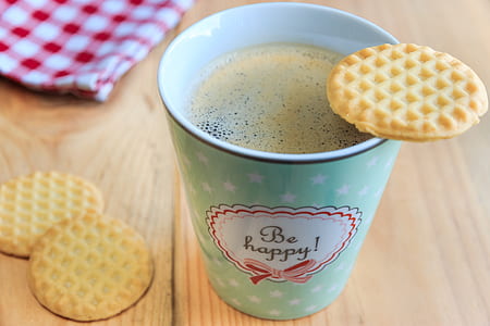 cooked waffle on cup filled with coffee