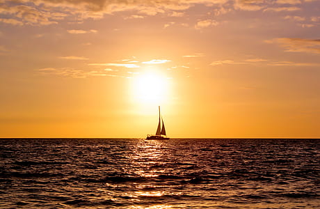 photography of sailing boat on body of water