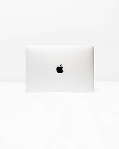 silver Apple MacBook on white surface