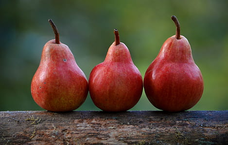 three oval red fruits