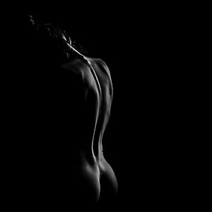 naked person on dark background