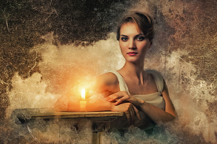woman in white sitting on chair with white candle