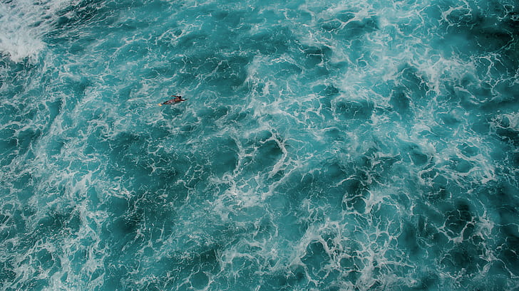 person swimming on sea