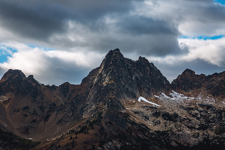 mountain summits under gray cloudy sky