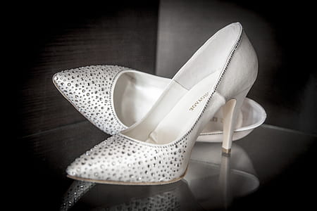 pair of white beaded leather pointed-toe pumps