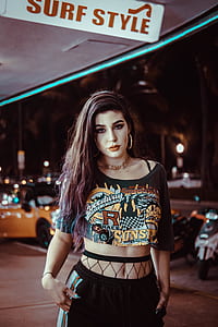 woman wearing black and yellow printed scoop-neck crop-top and black bottoms