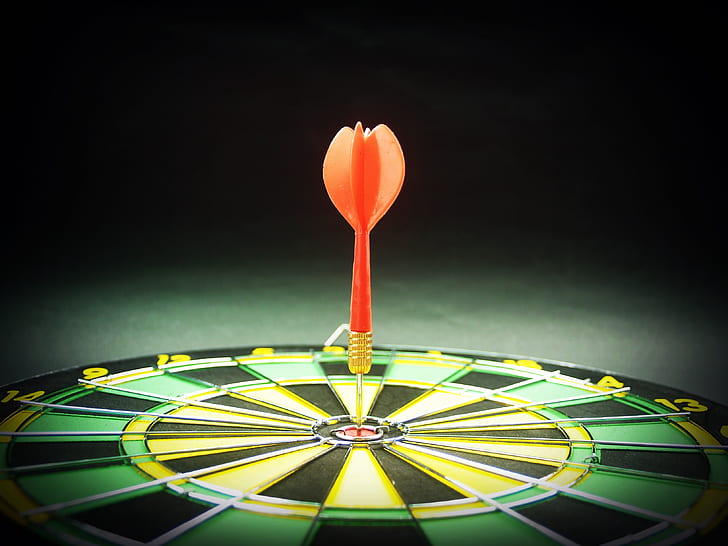 orange arrow on dartboard closeup photo