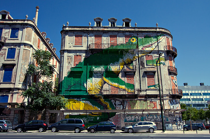 A large crocodile street art mural on the wall of a building in Lisbon, Portugal. Image captured with a Canon DSLR