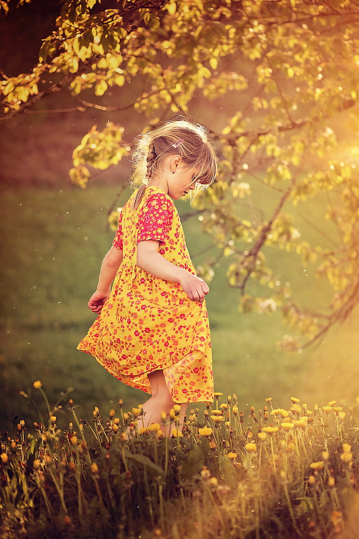 girl wearing yellow and red floral dress