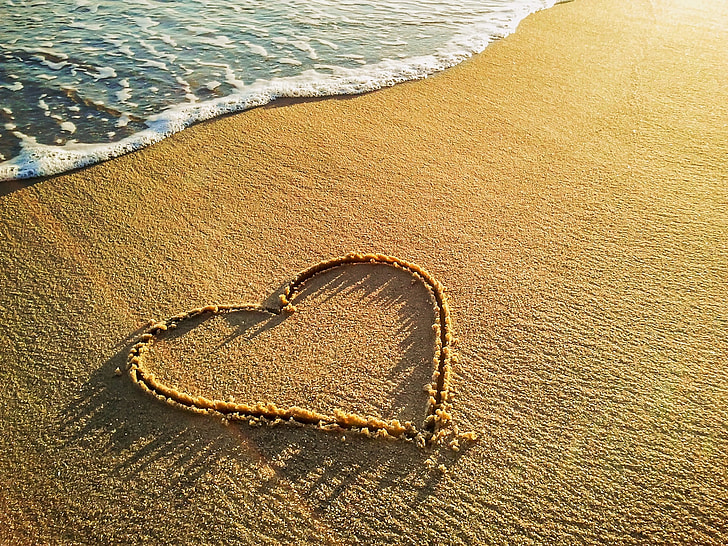 brown heart sand near sea shore