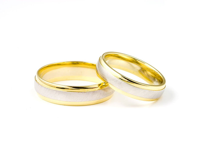 two silver-and-gold-colored bridal rings