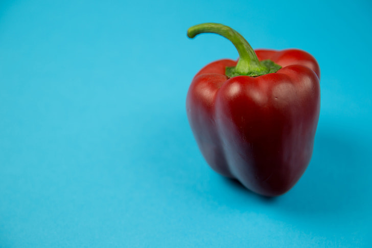Red pepper on blue background