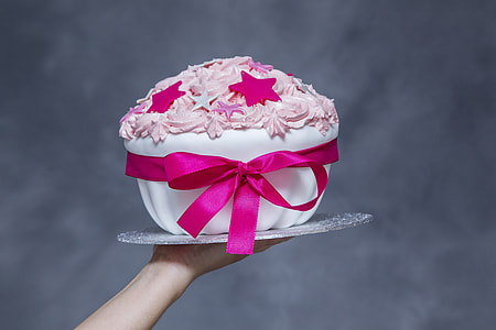 person holding fondant cake with star toppings