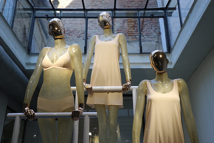 three woman mannequins on pole