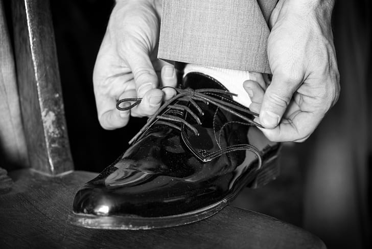 greyscale photo of dress shoe