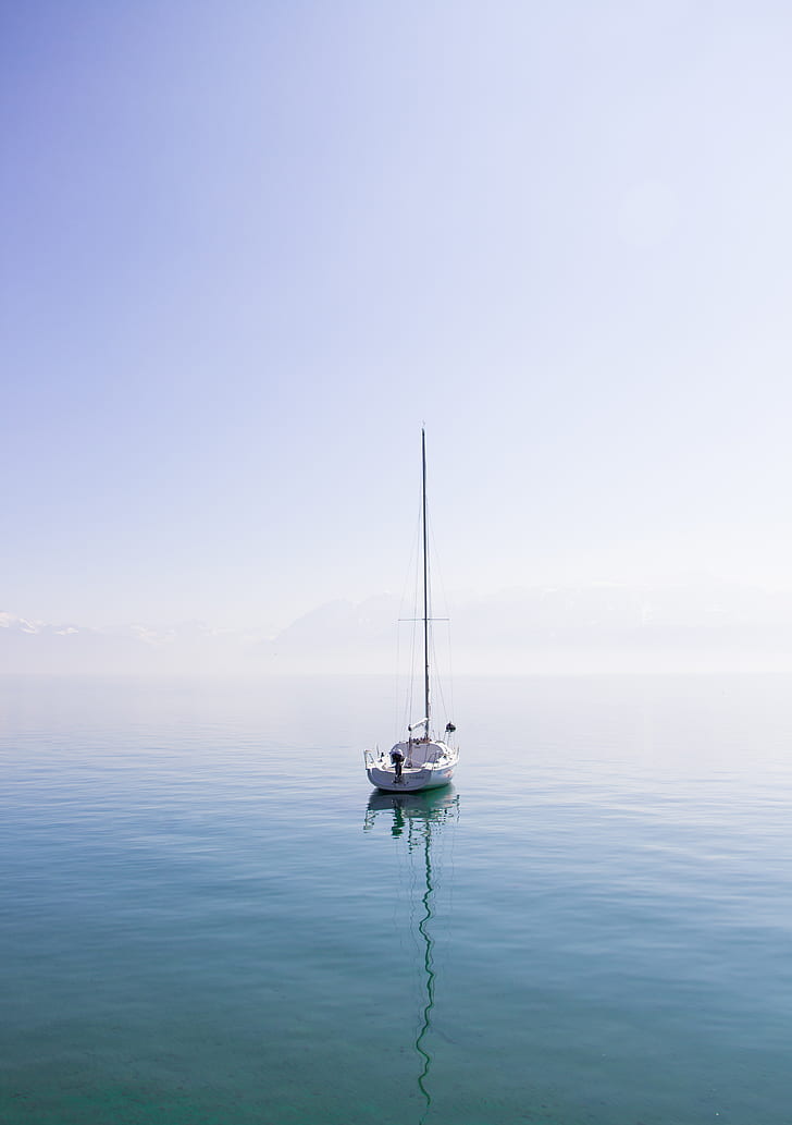 photo of white boat on body of water