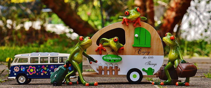 green ceramic frog figurines and brown trailer miniature