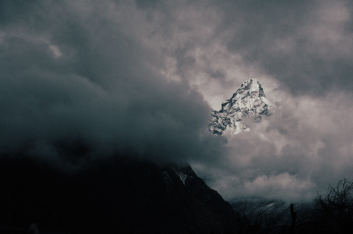 photo of mountain covered with clouds