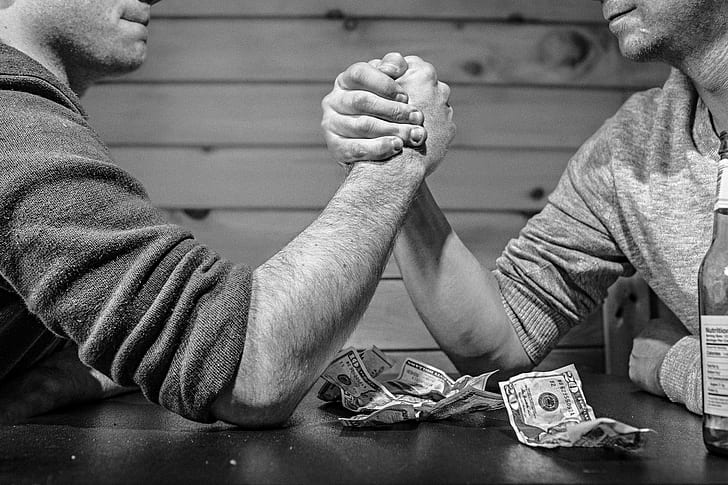 gray scale two man arm wrestling