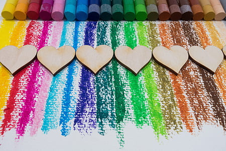 assorted color chalks near heart decoration