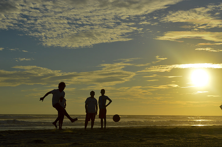silhouette photo of people playing in the beach