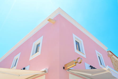 pink and white concrete building under blue sky during daytime