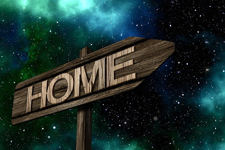 brown wooden Home signage under galaxy