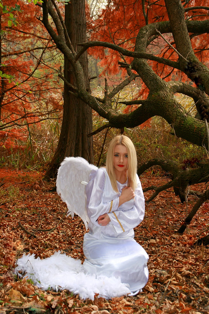 blonde-hair woman in angel dress near tree