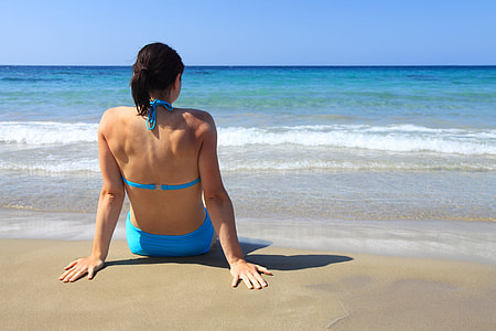 woman in blue 2-piece swimsuit on seashore