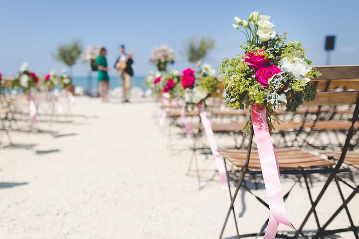 selective focus photography of wedding aisle flower arrangement