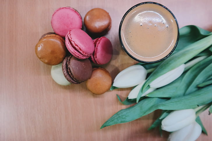 macaroons beside glass with brown liquid
