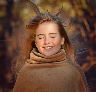 selective focus photography of girl smiling close eyes