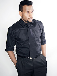man wearing black dress shirt and black bottoms