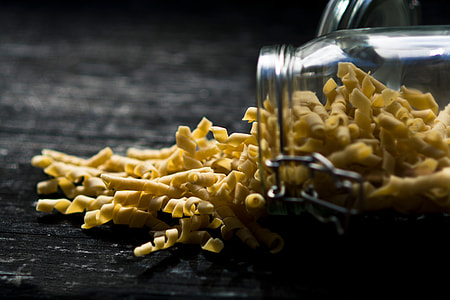 yellow pasta in clear glass container photography