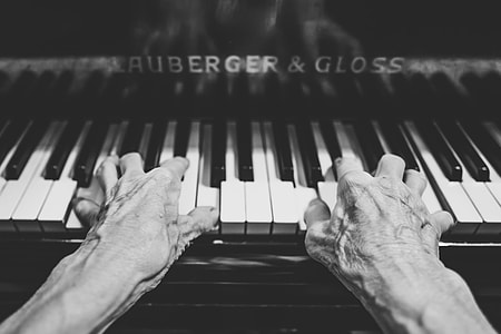 grayscale photo graphy of person playing piano