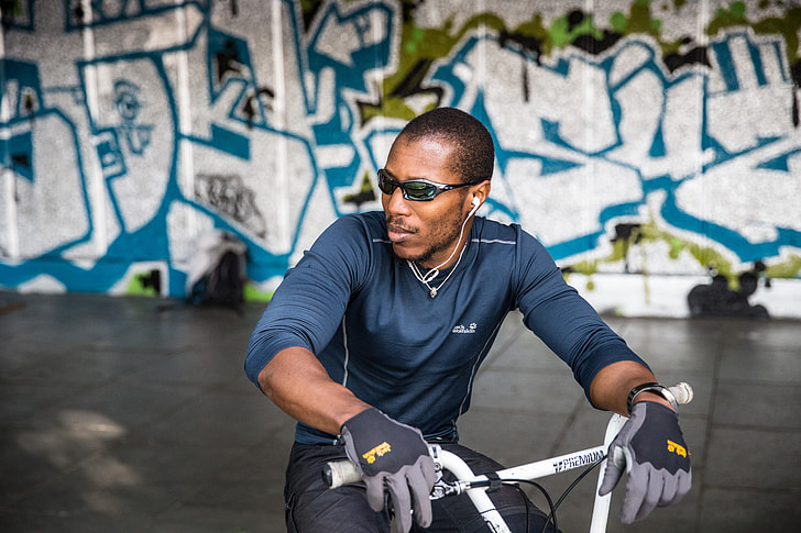 Portrait shot of a man in sunglasses sitting on a BMX bike, this image was captured on the Southbank in London using a Canon 6D DSLR