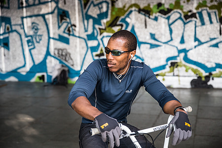 Portrait shot of a man in sunglasses sitting on a BMX bike, this image was captured on the Southbank in London using a Canon 6D DSLR