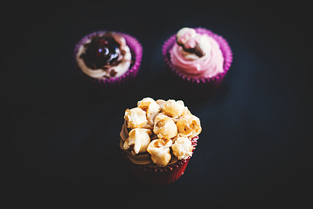 three cupcakes with icing toppings