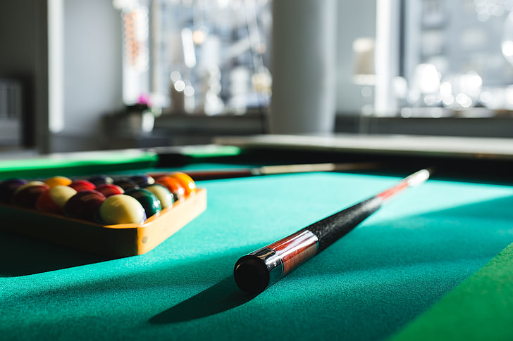 Royalty-Free photo: Billiard balls on green table with billiard cue - PickPik