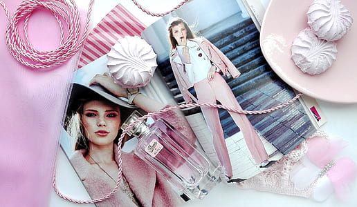 perfume bottle with woman's photo beside pink plate