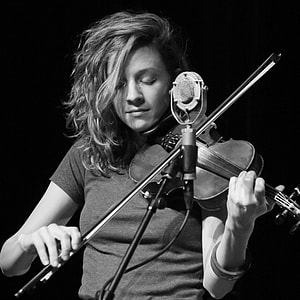 grayscale photography of woman playing violin