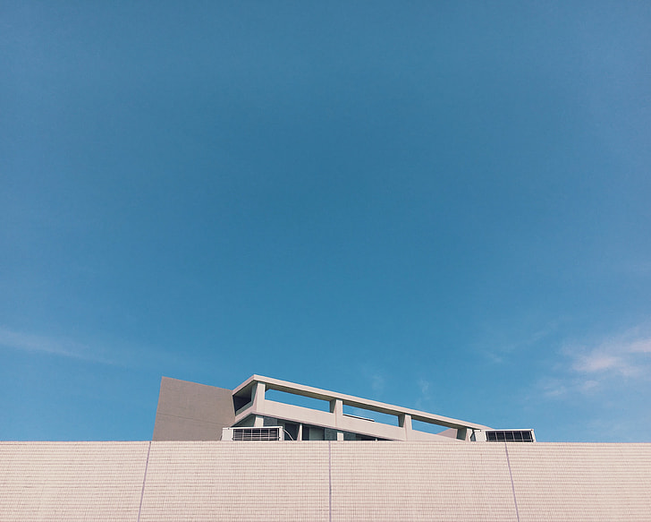 white concrete building under clear blue sky during daytime
