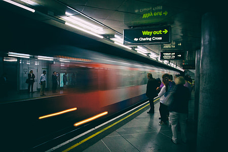 A train arrives for the waiting passengers on the platform of the London Underground network